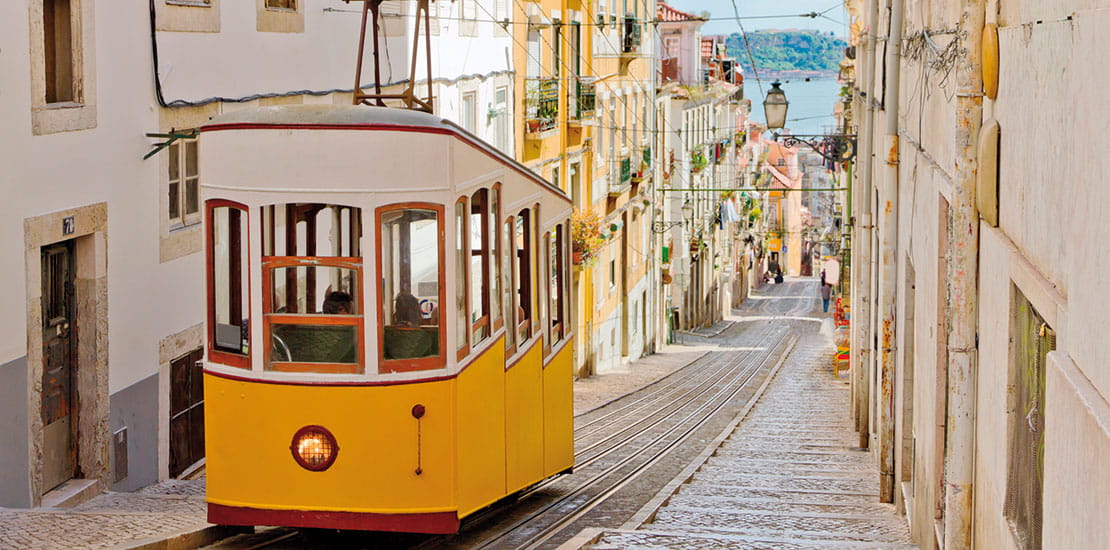 A tram travelling along a street in Lisbon, Portugal